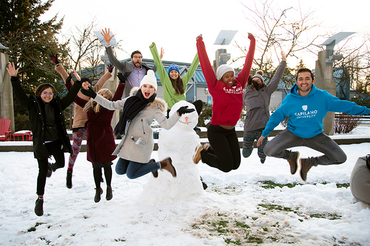 Students outside in snow jumping