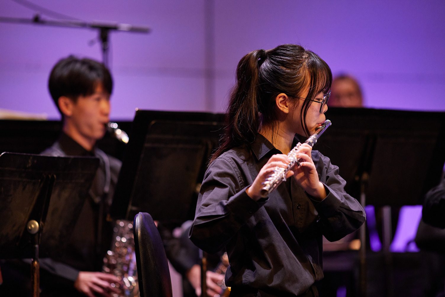 A Capilano University music student performing on flute at the BlueShore Financial Centre for the Performing Arts