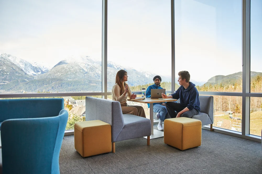 Capilano University students studying together with a mountain view