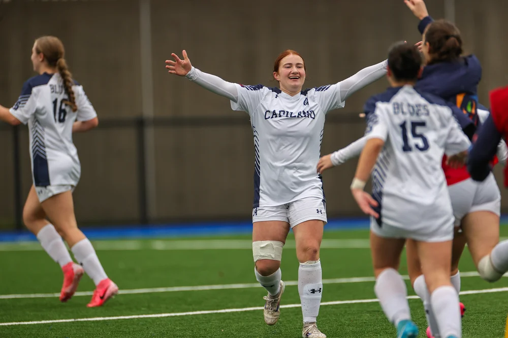 Isabella celebrates with teammates after a Capilano Blues match