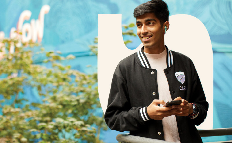 Student on campus holding phone