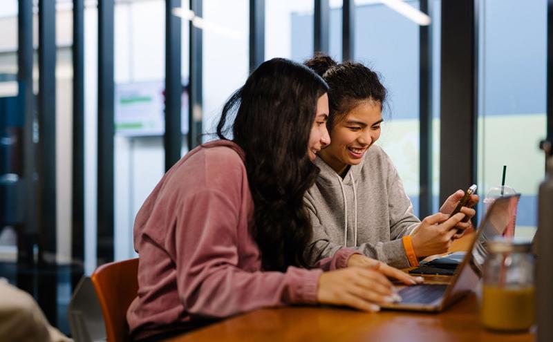 Two students looking at mobile phone