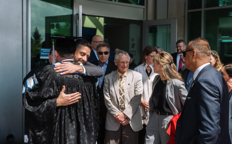 Caption: Guests gathered to warmly congratulate President Jason Dewling, celebrating the beginning of his leadership.