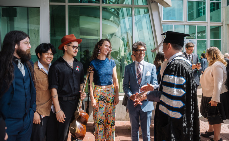 President Jason Dewling connects with performers from the CapU choir following the ceremony.