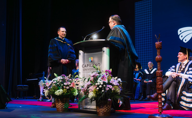Caption: RJ Wallia, board chair, administering the investiture and oath of office, formally affirming the new president’s commitment to serve and lead with integrity.