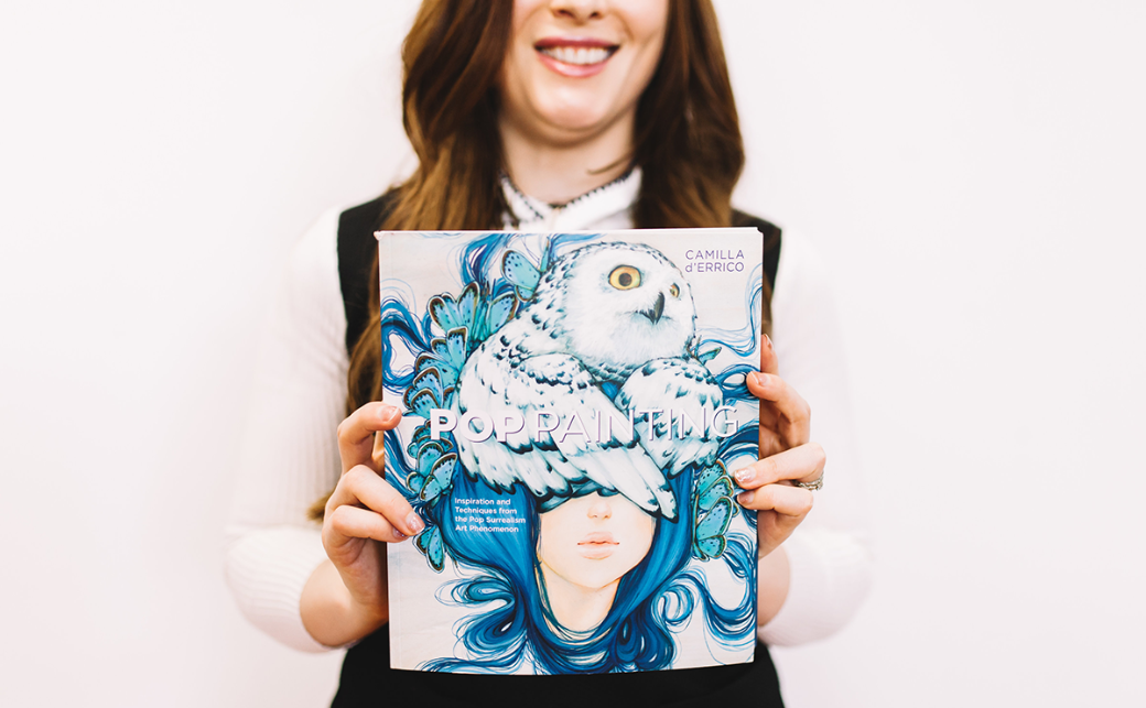 Camilla d'Errico holding her book 