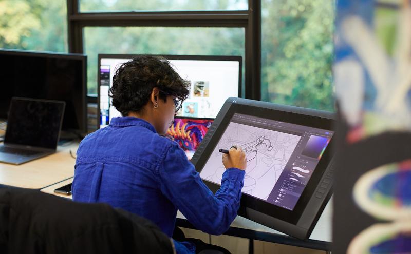 Student at desk working on computer