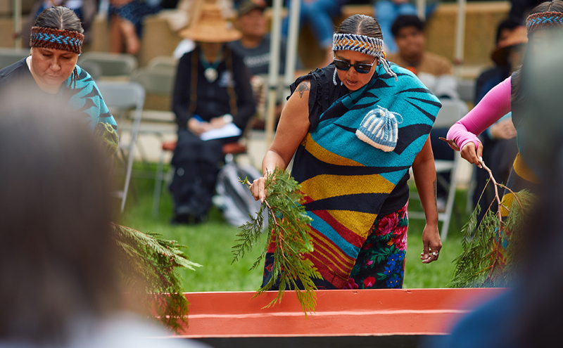 Cleaning canoe during Awakening Ceremony