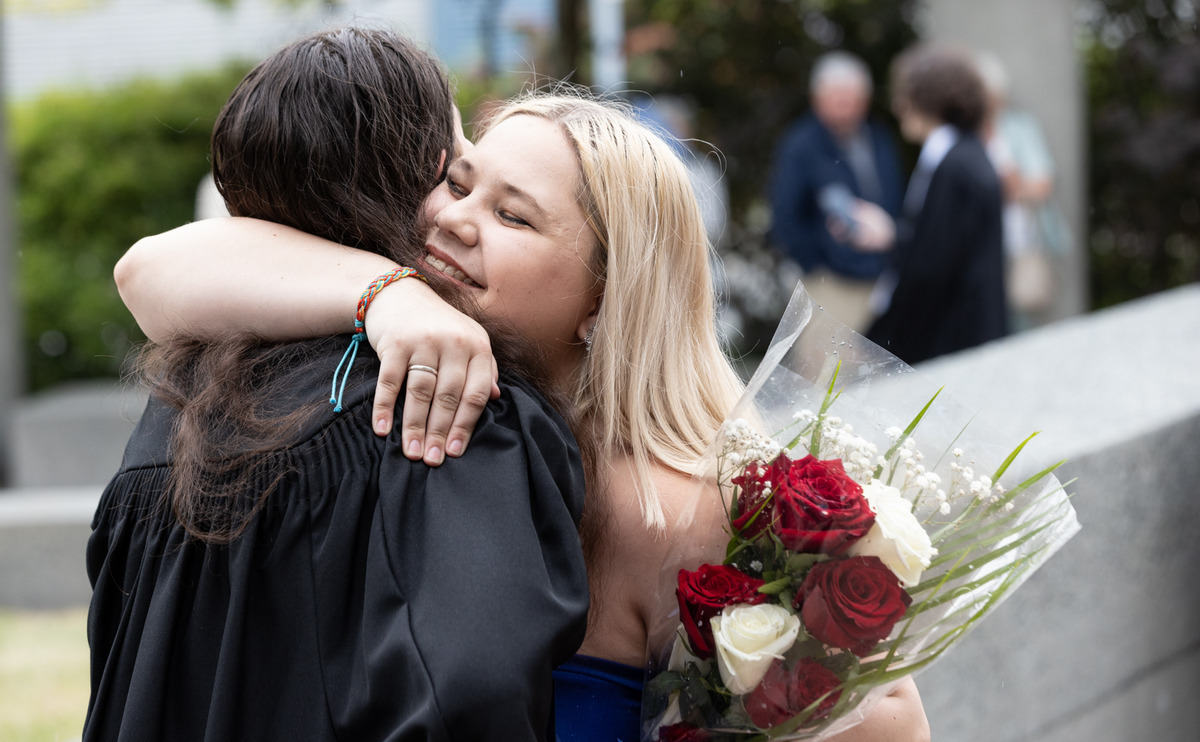 Two graduates hug at Convocation