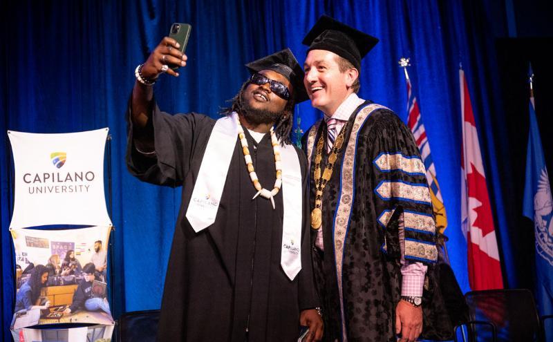 A student takes a selfie with Chancellor Yuri Fulmer