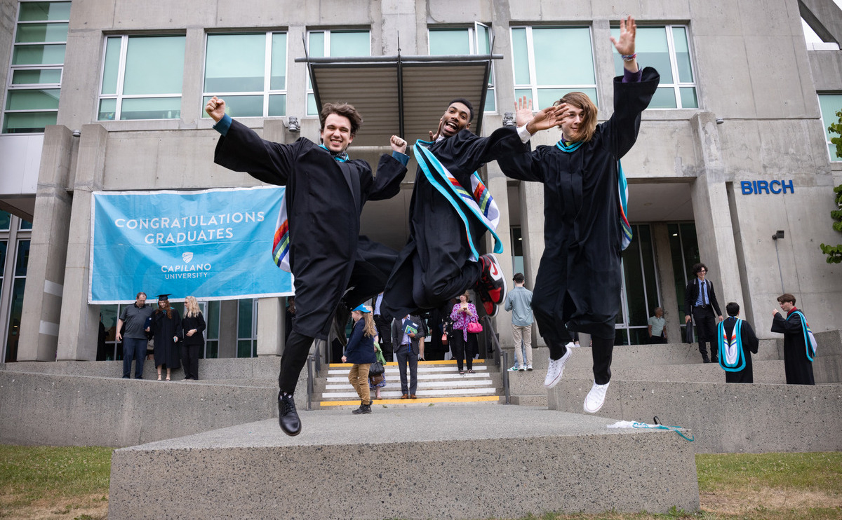 Students jumping in their gowns