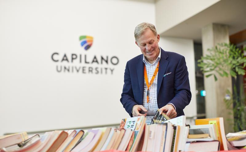 President Paul Dangerfield browsing through books at the United Way book sale