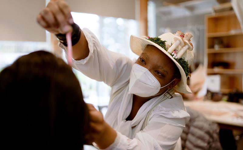 Costuming students in a millinery workshop