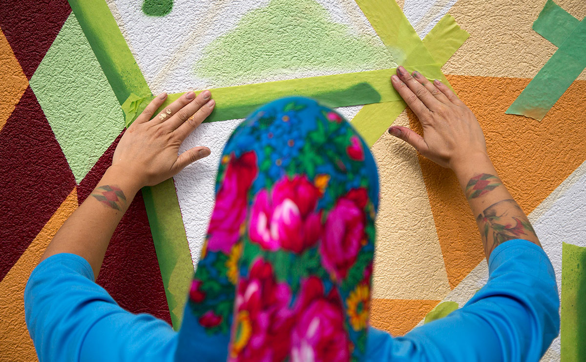 Carrielynn Victor working on her mural