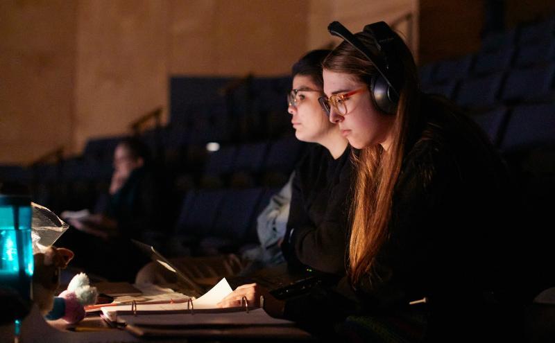 Students in booth at theatre performance