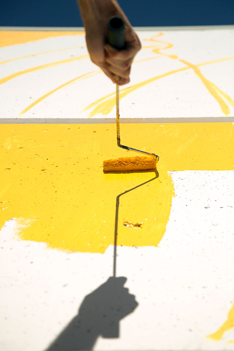 Cristian Fowlie painting his mural