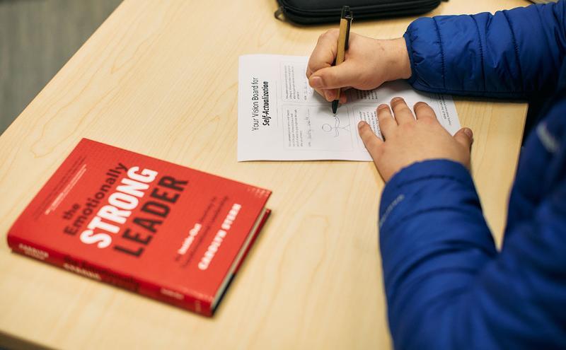 Student at desk with book