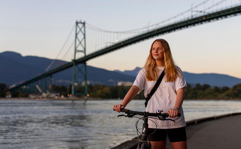 Grace Hardman walks bike on Stanley Park SeaWall