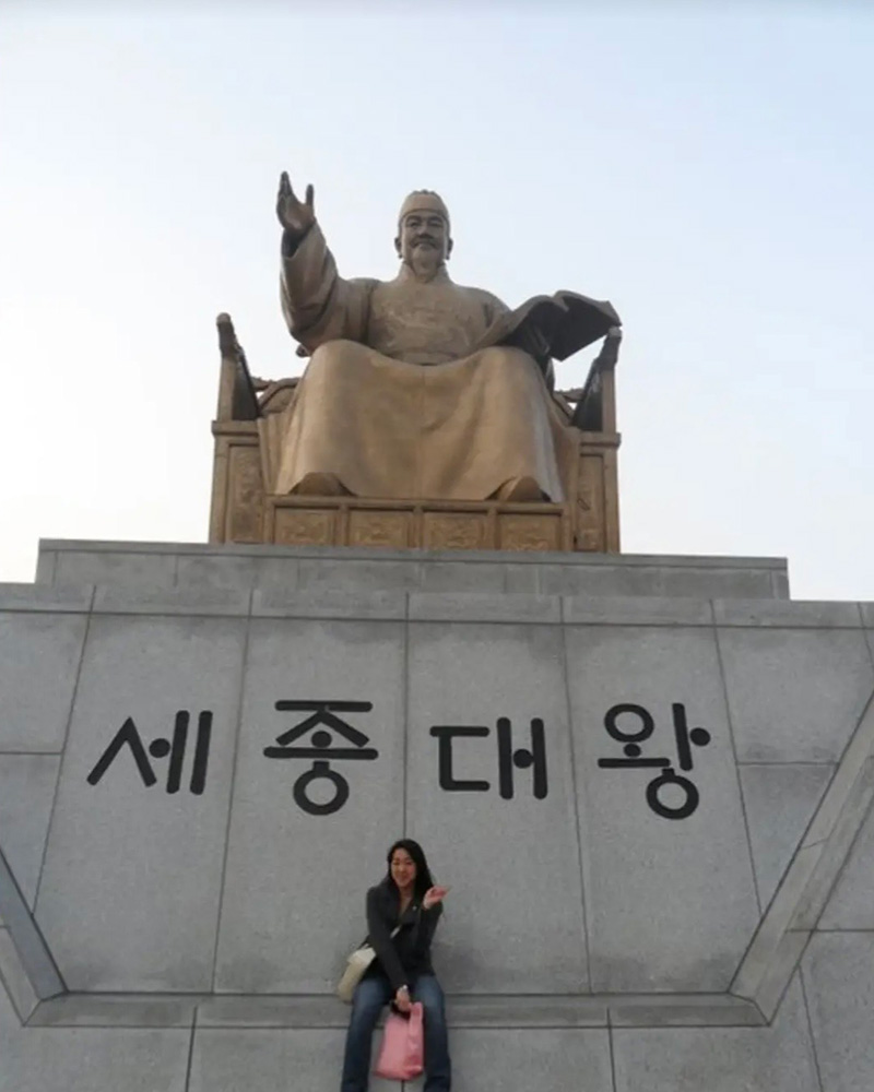 Grace Kim in Korea in front of statue