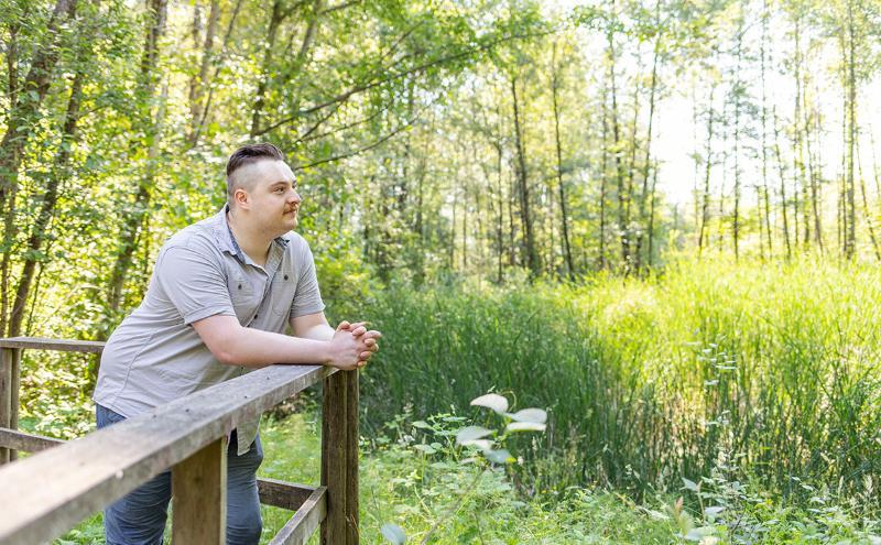 Photo of Harrison Smith looking at Maplewood Flats wetlands 