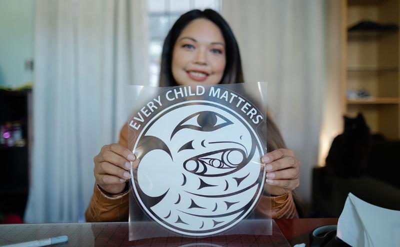 Marissa Nahanee holding her design as part of Opening Doors story