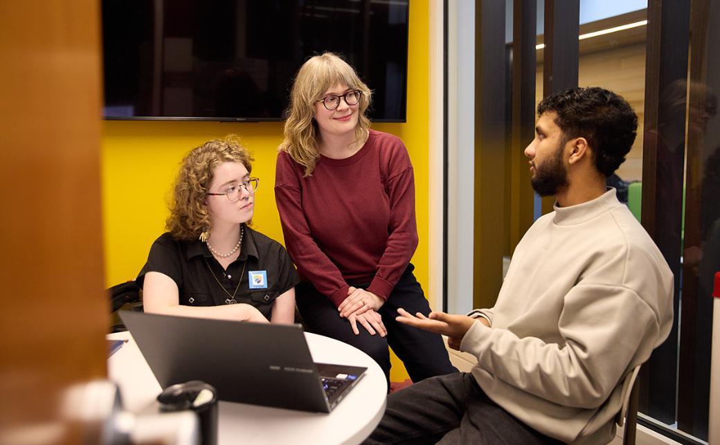 Instructor talking with students