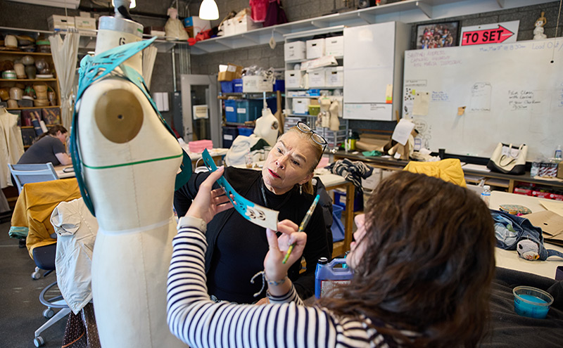 Pamela with a student during an Indigenous Costuming Intensive workshop, sharing her knowledge of design, materials and cultural storytelling through costume.