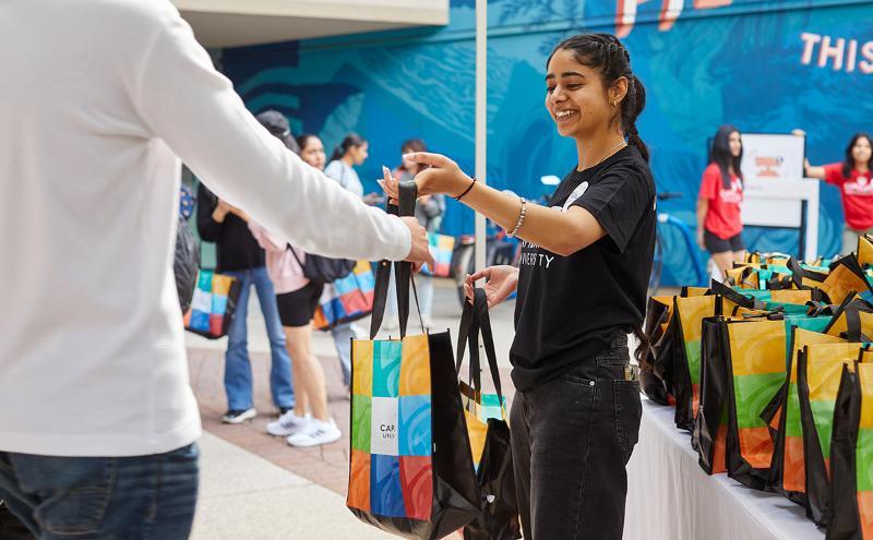 New students were greeted by volunteers with CapU swag