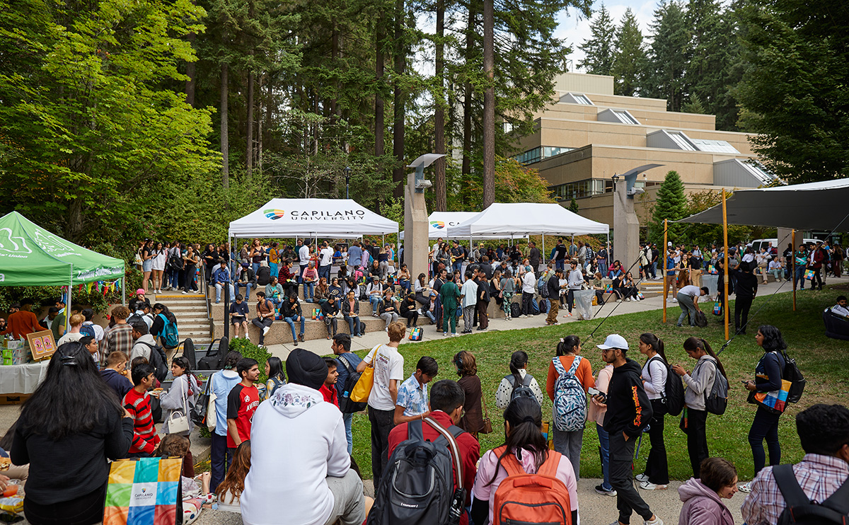 Students lining up for the free BBQ in the Cedar courtyard