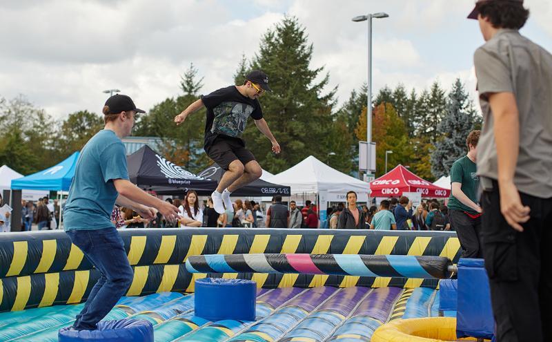 Testing their balance while navigating a giant inflatable obstacle course