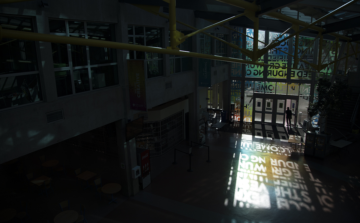 A silhouetted man walking out of the Birch building