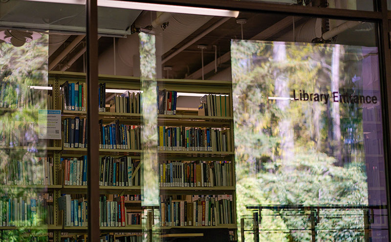 Trees reflecting in the windows of the CapU North Vancouver library.