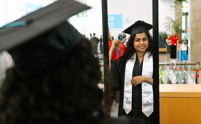 Making the final touches to their cap and gown