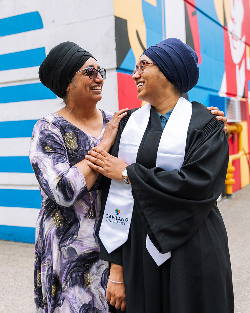 Mother and daughter share a smile on Convocation day