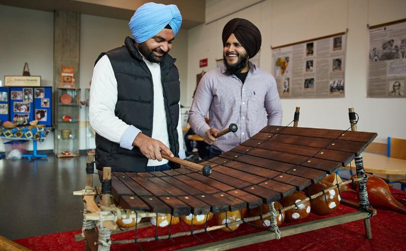 Students playing on a gyil (balafon), a traditional African instrument