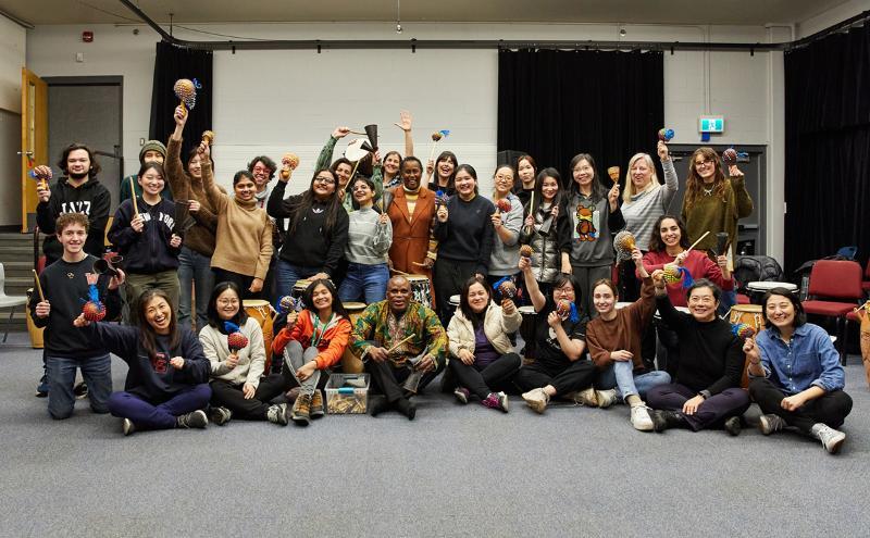 Students learning traditional African drumming and songs with instructor Kofi Gbolongo