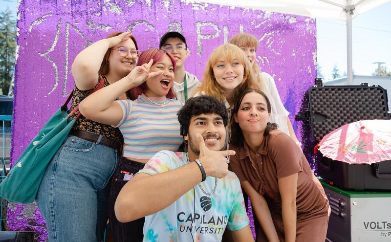 Returning students having fun in the photobooth