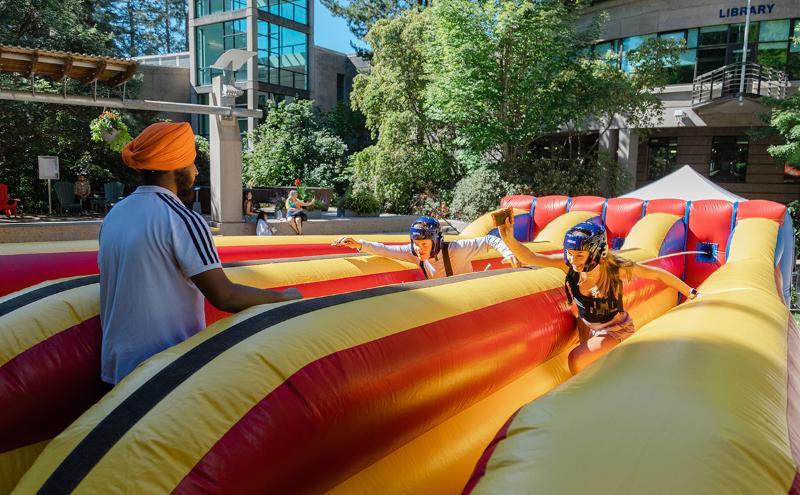 Testing their agility vs. fellow students in the inflatable obstacle course in Cedar Courtyard.