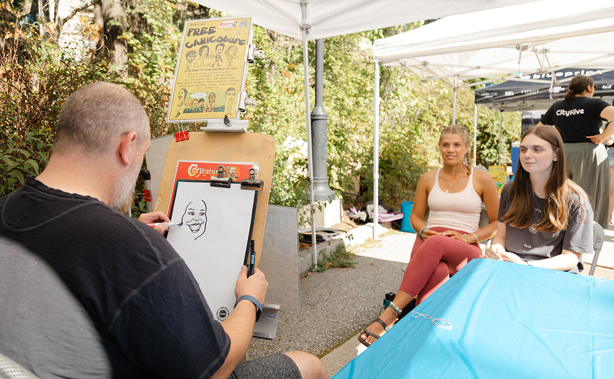 Students get a free caricature portrait from an artist as part of the event.