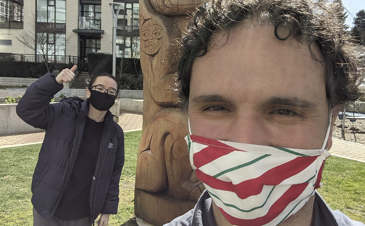 Selfie of Nazmi Kamal with a student, both wearing masks