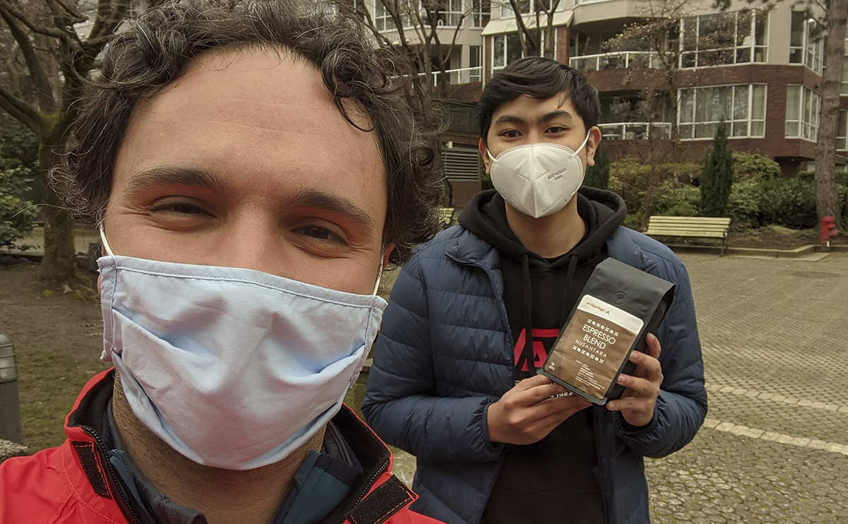 A selfie of Nazmi Kamal with a student, both wearing masks