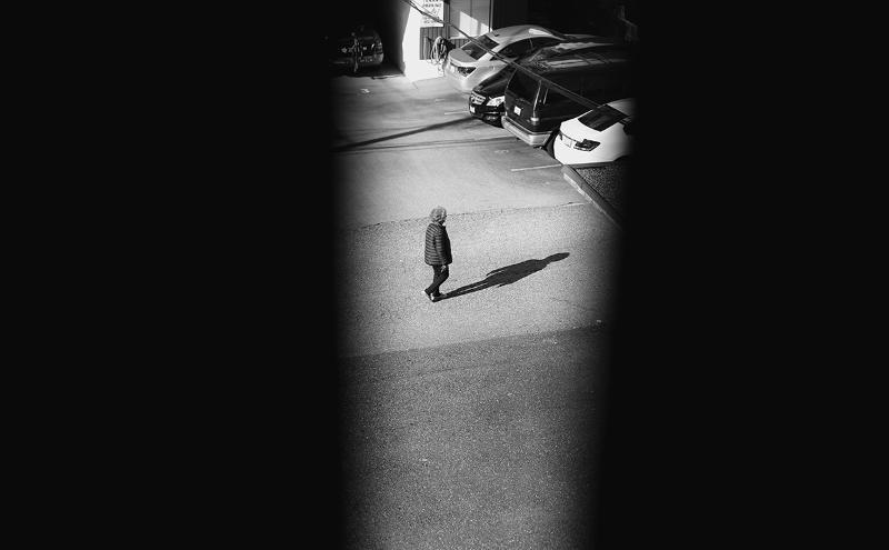 A photo of a woman walking outside. 
