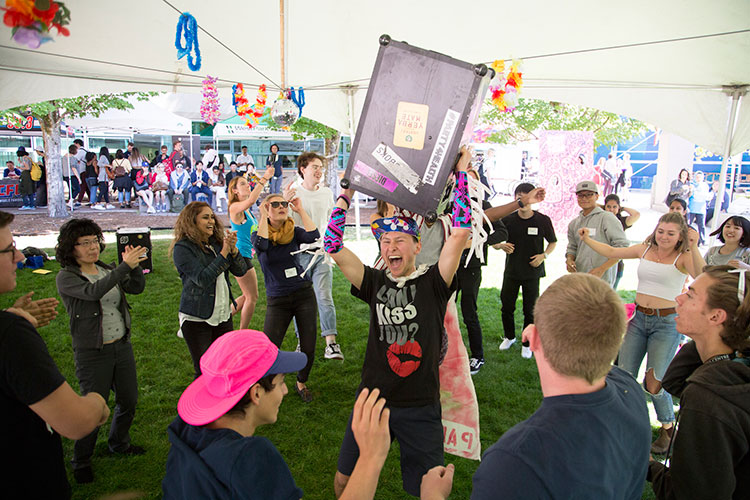 Founder and Director of Party4Health Jacques Martiquet, centre, dances with students during the orientation street party on Tuesday, Sept. 4, 2018.