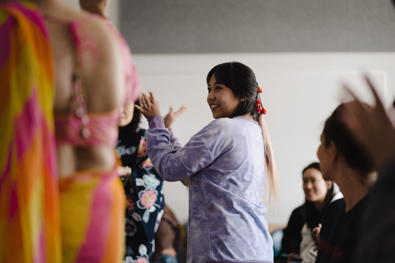 Students dancing at cultural dress and dance event for Asian Heritage Month at Cap U
