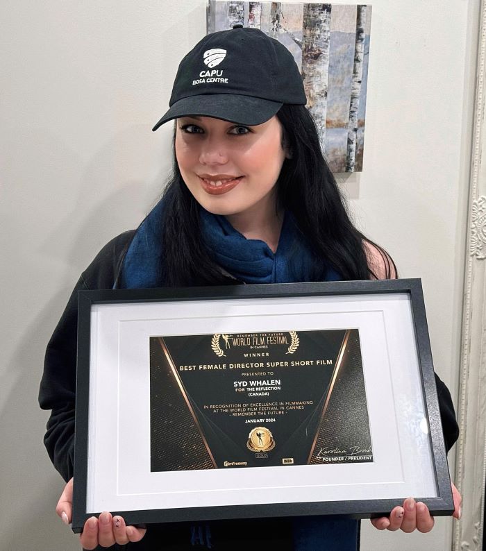 Whalen holding her Best Female Director Super Short Film award from Cannes World Film Festival.
