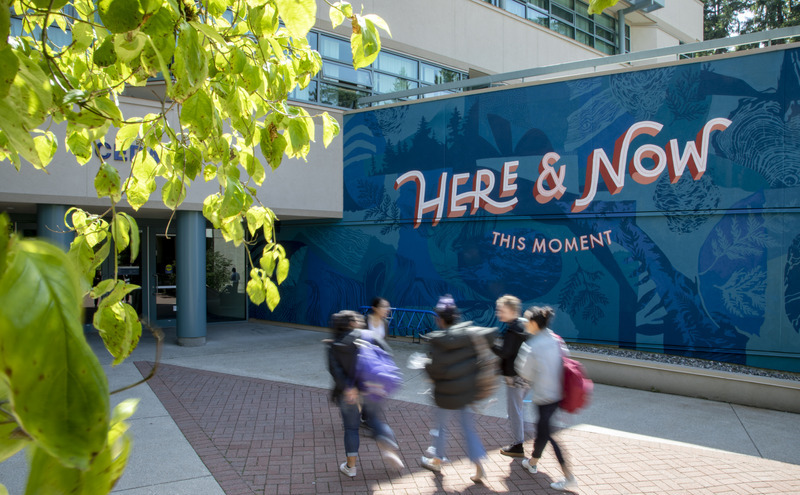 Students walking outside the Fir Building at CapU's main North Vancouver campus.