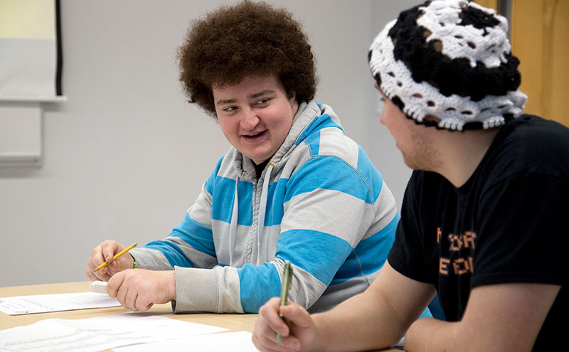 Students in classroom sitting beside each other