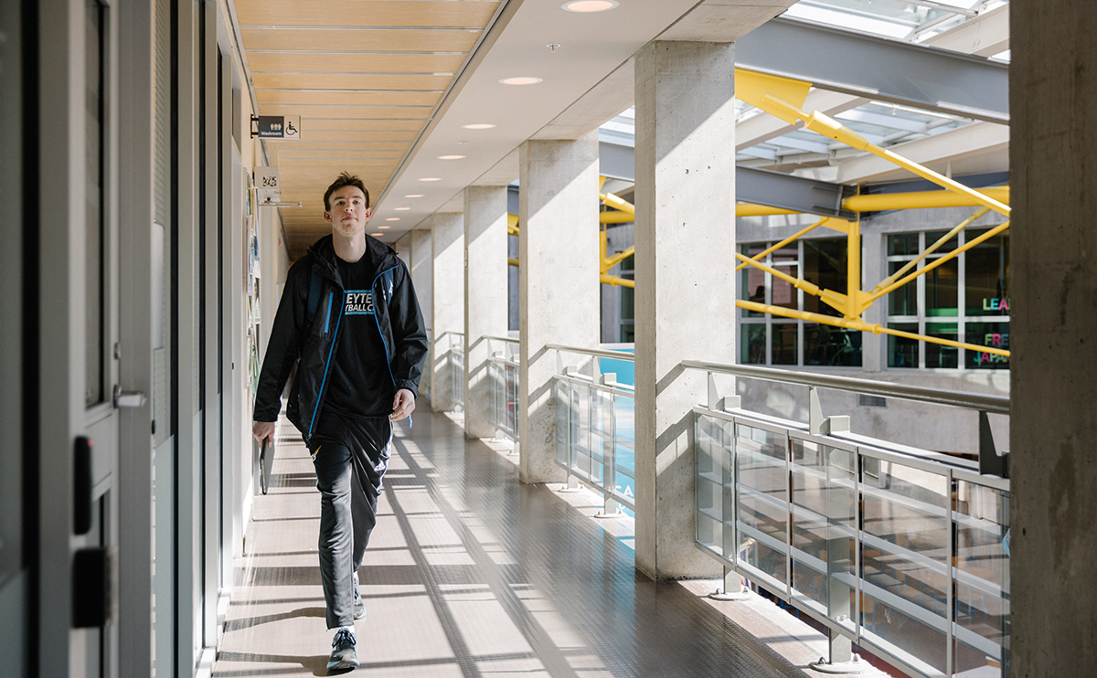 Student walking in Birch Building hallway
