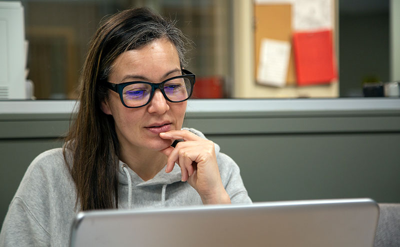 Student sitting at desk in front of computer