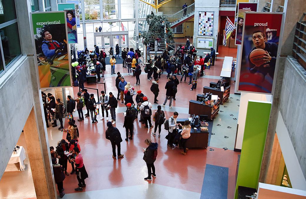 An overhead photograph of students standing around an open plaza on campus.